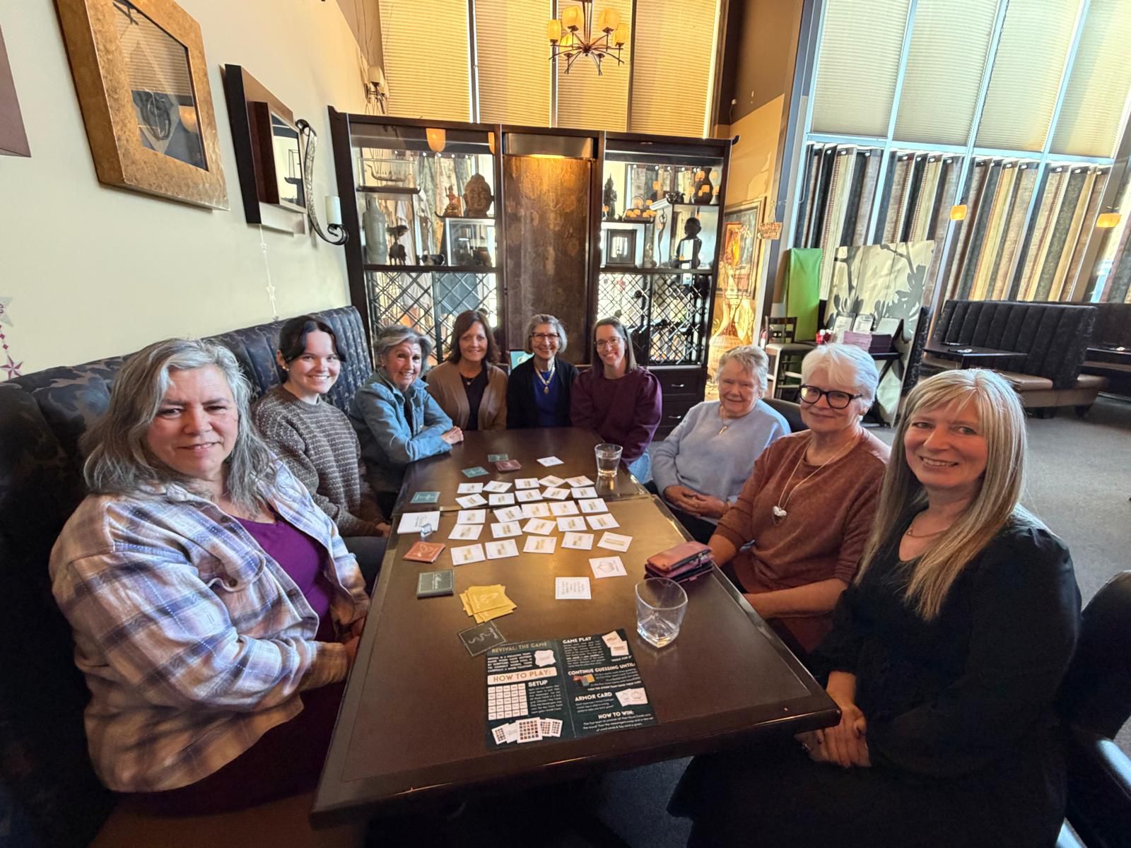Large women's group gathered around Revival at a restaurant